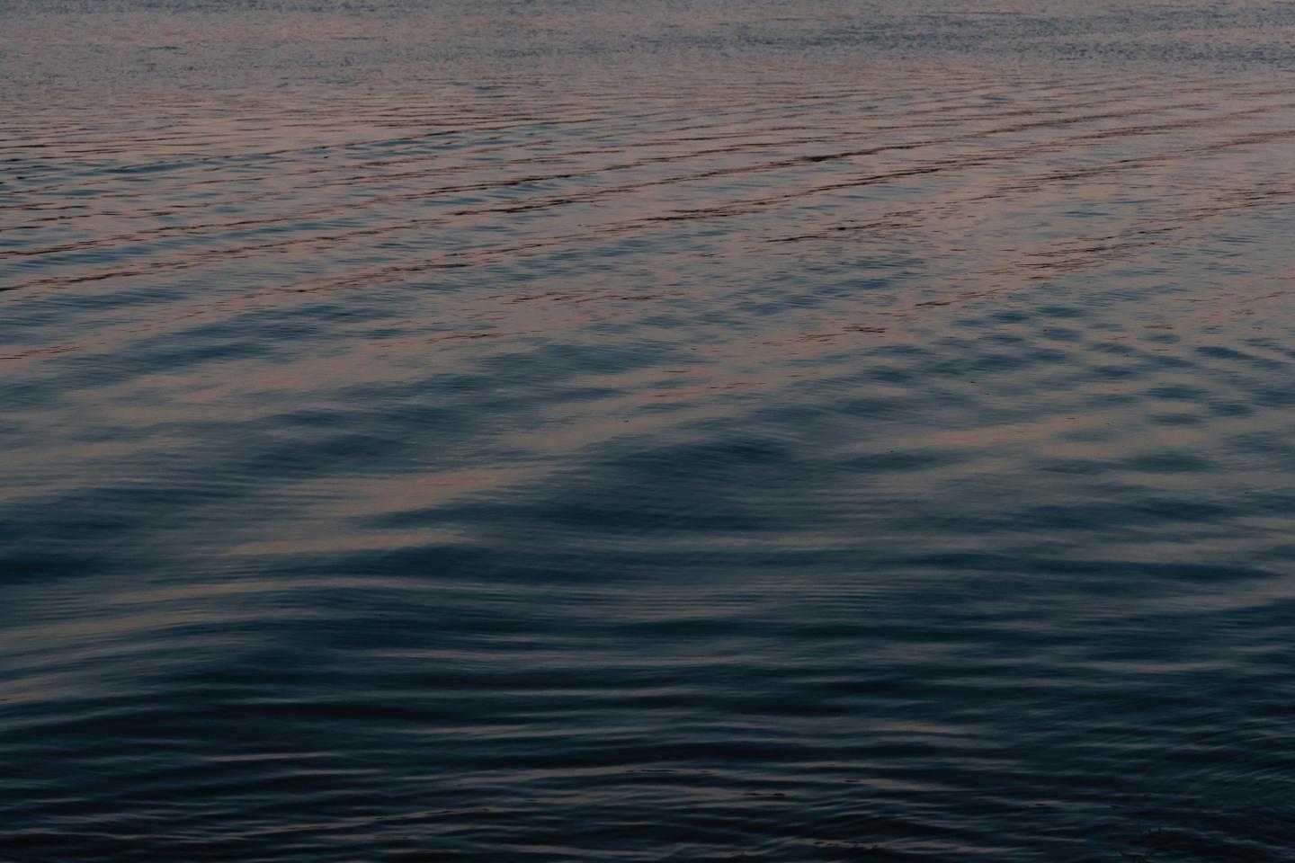 Rippled water with subtle reflections at dusk.